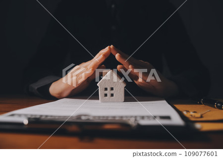 Real estate agent and customer signing contract to buy house, insurance or loan real estate.rent a house,get insurance or loan real estate or property. 109077601