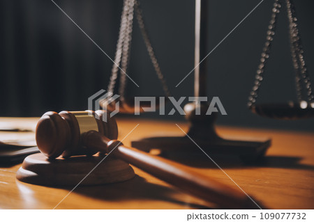 law books and scales of justice on desk in library of law firm. jurisprudence legal education concept. 109077732