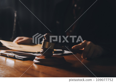 law books and scales of justice on desk in library of law firm. jurisprudence legal education concept. law books and scales of justice on desk in library of law firm. jurisprudence legal education concept. 109077752