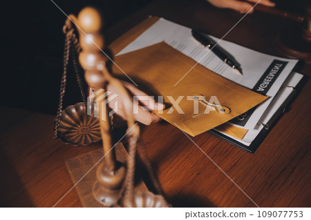 law books and scales of justice on desk in library of law firm. jurisprudence legal education concept. law books and scales of justice on desk in library of law firm. jurisprudence legal education concept. 109077753