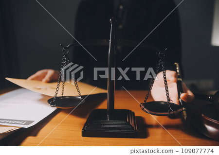 law books and scales of justice on desk in library of law firm. jurisprudence legal education concept. 109077774