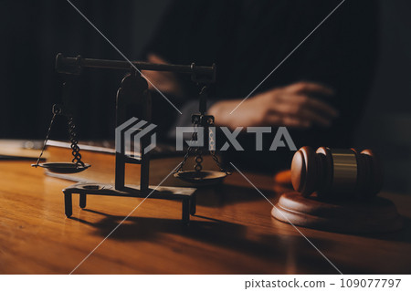 law books and scales of justice on desk in library of law firm. jurisprudence legal education concept. 109077797