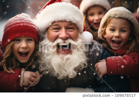 A playful and whimsical Santa Claus posing with a group of joyful children. Santa's rosy cheeks and the children's laughter convey the joy of the holiday season. 109078517