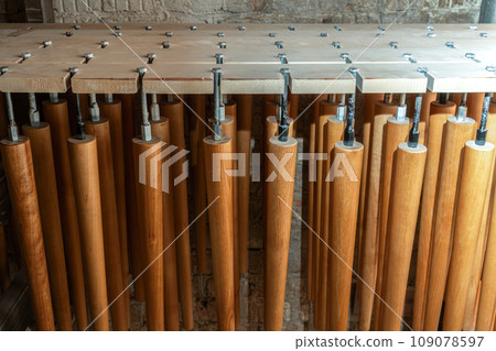 Set of wooden furniture legs drying after applying varnish 109078597