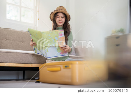 Beauty asian traveler woman packing prepare stuff and outfit clothes in suitcase travel bag luggage for holidays at home, weekend, tourist, journey 109079345