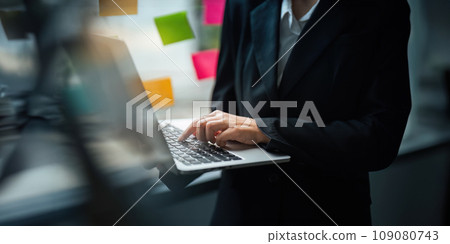 Close up Asian business woman using laptop to calculate tax and financial data of business at office Close up Asian business woman using laptop to calculate tax and financial data of business at office 109080743