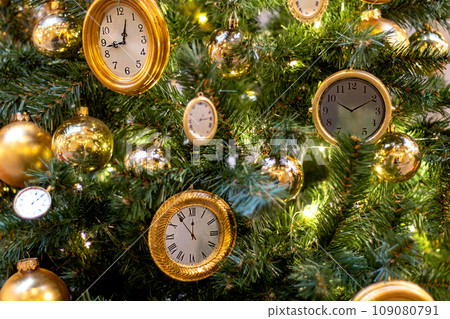 Lots of different gold watches on Christmas tree. Festive decorations 109080791
