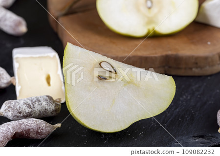 delicious and ripe pear on a wooden board delicious and ripe pear on a wooden board 109082232