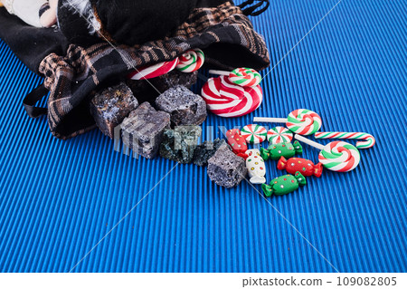 The Befana with sweet coal and candy. Italian Epiphany day tradition. The Befana with sweet coal and candy. Italian Epiphany day tradition. 109082805