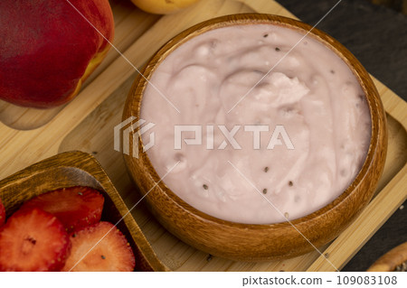 fresh yogurt made from milk with pieces of strawberries fresh yogurt made from milk with pieces of strawberries 109083108