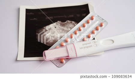 Pregnancy test with ultrasound scan photo of fetus, maternity, childbirth, birth control. 109083634