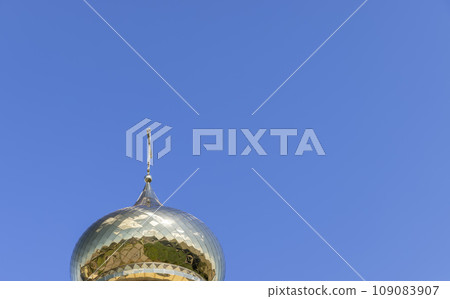 wooden christian cross on a blue sky background wooden christian cross on a blue sky background 109083907