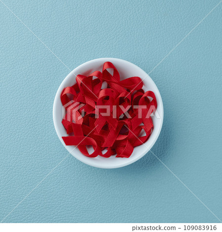 bowl with some red awareness ribbons bowl with some red awareness ribbons 109083916