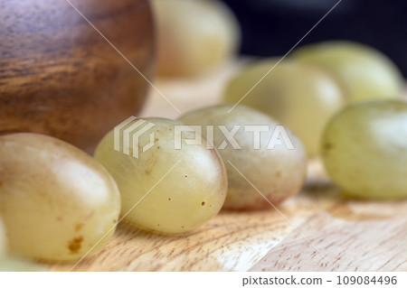 Homemade green unwashed grapes on a board 109084496