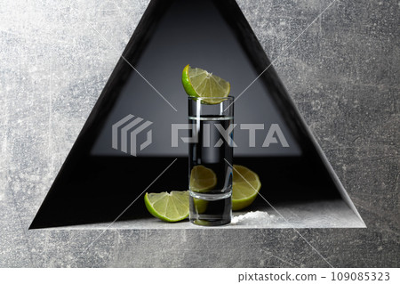 Tequila with lime slices and sea salt. 109085323