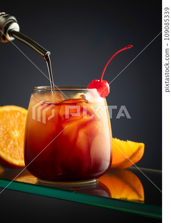 Making the Tequila Sunrise cocktail. Making the Tequila Sunrise cocktail. 109085339