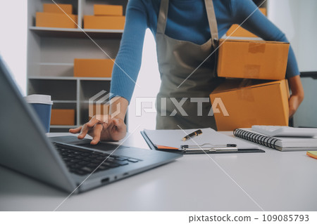 Business woman start up small business entrepreneur SME success .freelance woman working at home with Online Parcel delivery. SME and packaging deliveryconcept 109085793