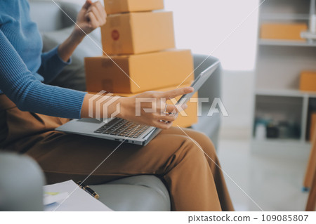 Business woman start up small business entrepreneur SME success .freelance woman working at home with Online Parcel delivery. SME and packaging deliveryconcept Business woman start up small business entrepreneur SME success .freelance woman working at home with Online Parcel delivery. SME and packaging deliveryconcept 109085807