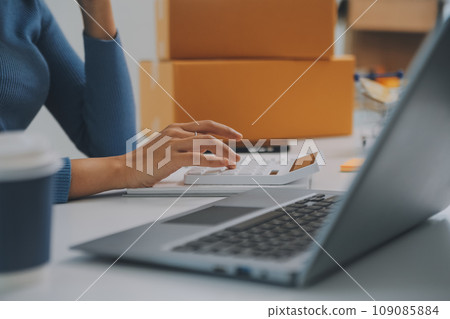 Business woman start up small business entrepreneur SME success .freelance woman working at home with Online Parcel delivery. SME and packaging deliveryconcept Business woman start up small business entrepreneur SME success .freelance woman working at home with Online Parcel delivery. SME and packaging deliveryconcept 109085884