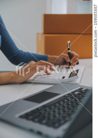 Business woman start up small business entrepreneur SME success .freelance woman working at home with Online Parcel delivery. SME and packaging deliveryconcept 109085887