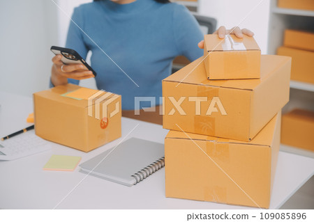 Business woman start up small business entrepreneur SME success .freelance woman working at home with Online Parcel delivery. SME and packaging deliveryconcept Business woman start up small business entrepreneur SME success .freelance woman working at home with Online Parcel delivery. SME and packaging deliveryconcept 109085896