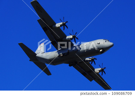 C-130 Hercules flying in the blue sky 109086709