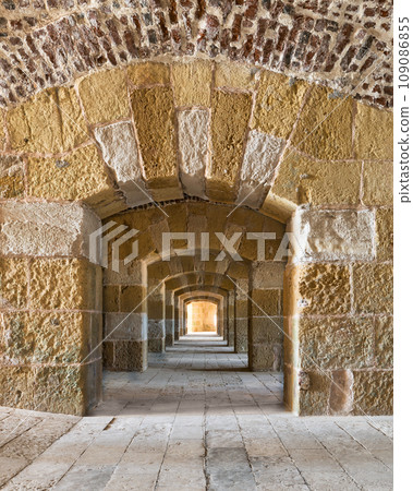 Stone arches in 15th century Citadel of Qaitbay, Alexandria, Egypt. Made of red and yellow sandstone Stone arches in 15th century Citadel of Qaitbay, Alexandria, Egypt. Made of red and yellow sandstone 109086855