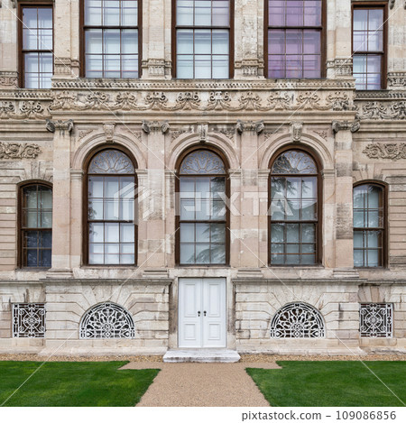 Side wall at Dolmabahce Palace, with small door and arched windows, Besiktas district, Bosphorus, Istanbul, Turkey 109086856