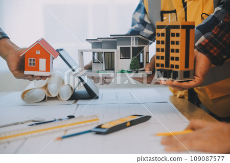 Construction and structure concept of Engineer or architect meeting for project working with partner and engineering tools on model building and blueprint in working site, contract for both companies. Construction and structure concept of Engineer or architect meeting for project working with partner and engineering tools on model building and blueprint in working site, contract for both companies. 109087577