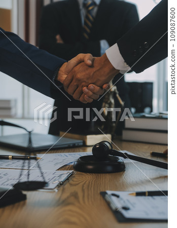 Consultation and conference of Male lawyers and professional businesswoman working and discussion having at law firm in office. Concepts of law, Judge gavel with scales of justice. 109087600