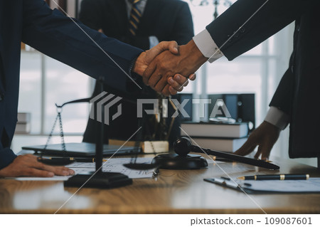 Consultation and conference of Male lawyers and professional businesswoman working and discussion having at law firm in office. Concepts of law, Judge gavel with scales of justice. 109087601