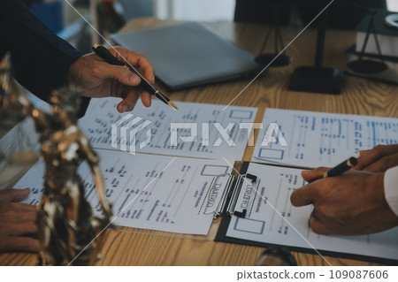 Consultation and conference of Male lawyers and professional businesswoman working and discussion having at law firm in office. Concepts of law, Judge gavel with scales of justice. Consultation and conference of Male lawyers and professional businesswoman working and discussion having at law firm in office. Concepts of law, Judge gavel with scales of justice. 109087606