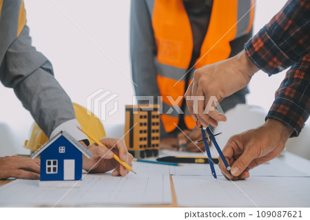 Construction and structure concept of Engineer or architect meeting for project working with partner and engineering tools on model building and blueprint in working site, contract for both companies. Construction and structure concept of Engineer or architect meeting for project working with partner and engineering tools on model building and blueprint in working site, contract for both companies. 109087621