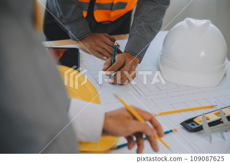 Construction and structure concept of Engineer or architect meeting for project working with partner and engineering tools on model building and blueprint in working site, contract for both companies. Construction and structure concept of Engineer or architect meeting for project working with partner and engineering tools on model building and blueprint in working site, contract for both companies. 109087625