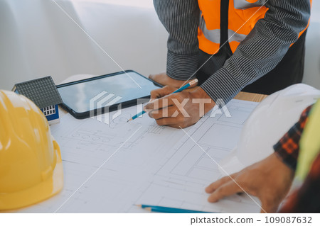 Construction and structure concept of Engineer or architect meeting for project working with partner and engineering tools on model building and blueprint in working site, contract for both companies. 109087632