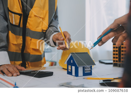 Construction and structure concept of Engineer or architect meeting for project working with partner and engineering tools on model building and blueprint in working site, contract for both companies. 109087638