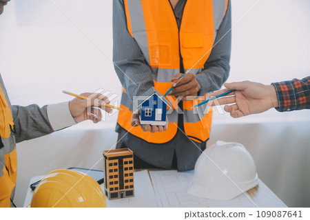 Construction and structure concept of Engineer or architect meeting for project working with partner and engineering tools on model building and blueprint in working site, contract for both companies. Construction and structure concept of Engineer or architect meeting for project working with partner and engineering tools on model building and blueprint in working site, contract for both companies. 109087641