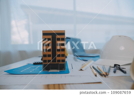 Construction and structure concept of Engineer or architect meeting for project working with partner and engineering tools on model building and blueprint in working site, contract for both companies. Construction and structure concept of Engineer or architect meeting for project working with partner and engineering tools on model building and blueprint in working site, contract for both companies. 109087659