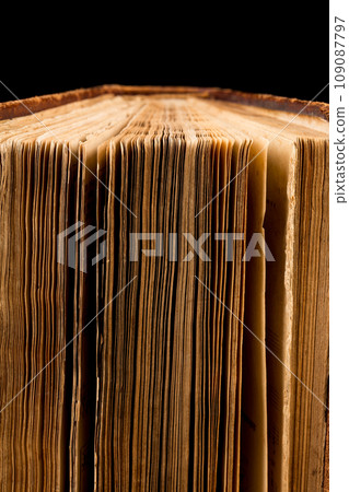 ancient book shot on black background ancient book shot on black background 109087797
