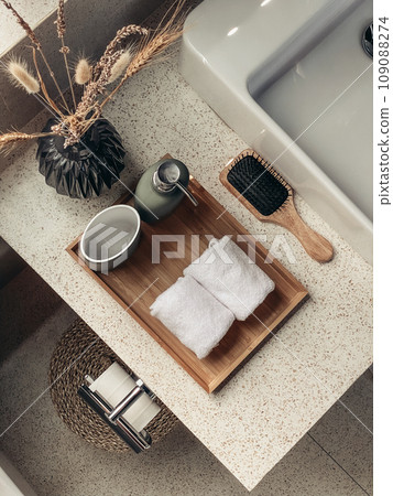Two hand towels in the bathroom with liquid soap dispenser on bamboo tray Two hand towels in the bathroom with liquid soap dispenser on bamboo tray 109088274