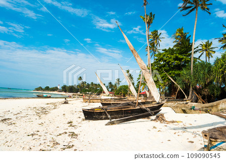 sailing boats with masts sitting at ocean shore sailing boats with masts sitting at ocean shore 109090545