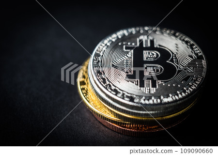Pile of bitcoin coins on dark background Pile of bitcoin coins on dark background 109090660