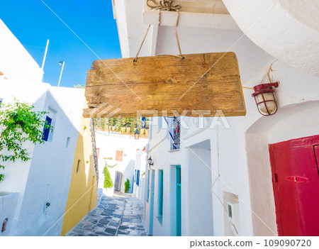 Empty wooden signboard hanging on the rope, Greece 109090720