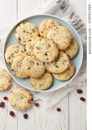 Cranberry Orange Shortbread Cookies are the perfect holiday cookie for the festive season closeup on the plate. Vertical top view 109091404