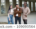 Three young people posing looking at the camera, with a gesture of empowerment. 109093564