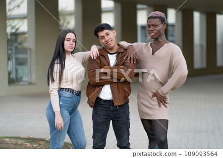 Three young people posing looking at the camera, with a gesture of empowerment. 109093564