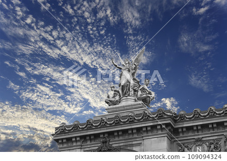 Golden statue of Liberty on the roof of the Opera Garnier (Garnier Palace) against the sky with clouds. Sculpted by Charles Gumery in 1869. Paris, France. UNESCO World Heritage Site Golden statue of Liberty on the roof of the Opera Garnier (Garnier Palace) against the sky with clouds. Sculpted by Charles Gumery in 1869. Paris, France. UNESCO World Heritage Site 109094324
