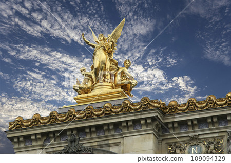 Golden statue of Liberty on the roof of the Opera Garnier (Garnier Palace) against the sky with clouds. Sculpted by Charles Gumery in 1869. Paris, France. UNESCO World Heritage Site Golden statue of Liberty on the roof of the Opera Garnier (Garnier Palace) against the sky with clouds. Sculpted by Charles Gumery in 1869. Paris, France. UNESCO World Heritage Site 109094329
