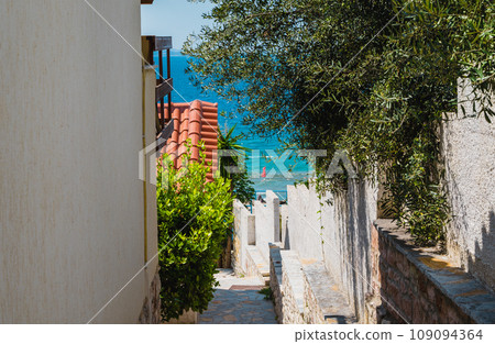 summer scene of street of Saranda. Ioninian seascape. Albania, Europe. Traveling concept background. summer scene of street of Saranda. Ioninian seascape. Albania, Europe. Traveling concept background. 109094364