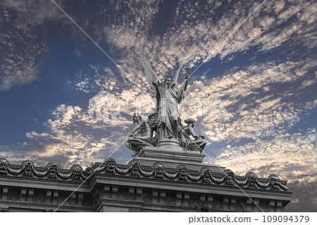 Golden statue of Liberty on the roof of the Opera Garnier (Garnier Palace)  against the sky at sunset. Sculpted by Charles Gumery in 1869. Paris, France. UNESCO World Heritage Site 109094379